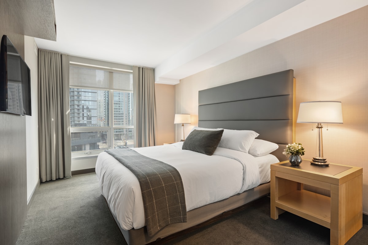 Boutique hotel suite with warm lighting and layered bedding